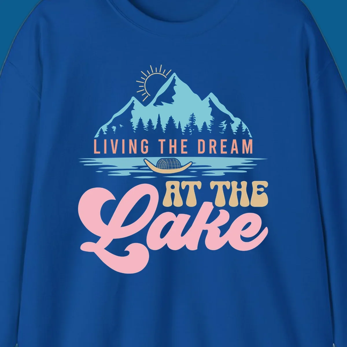 Illustration of mountains and lake with text 'Living The Dream At The Lake', representing the lake-life-dream concept.