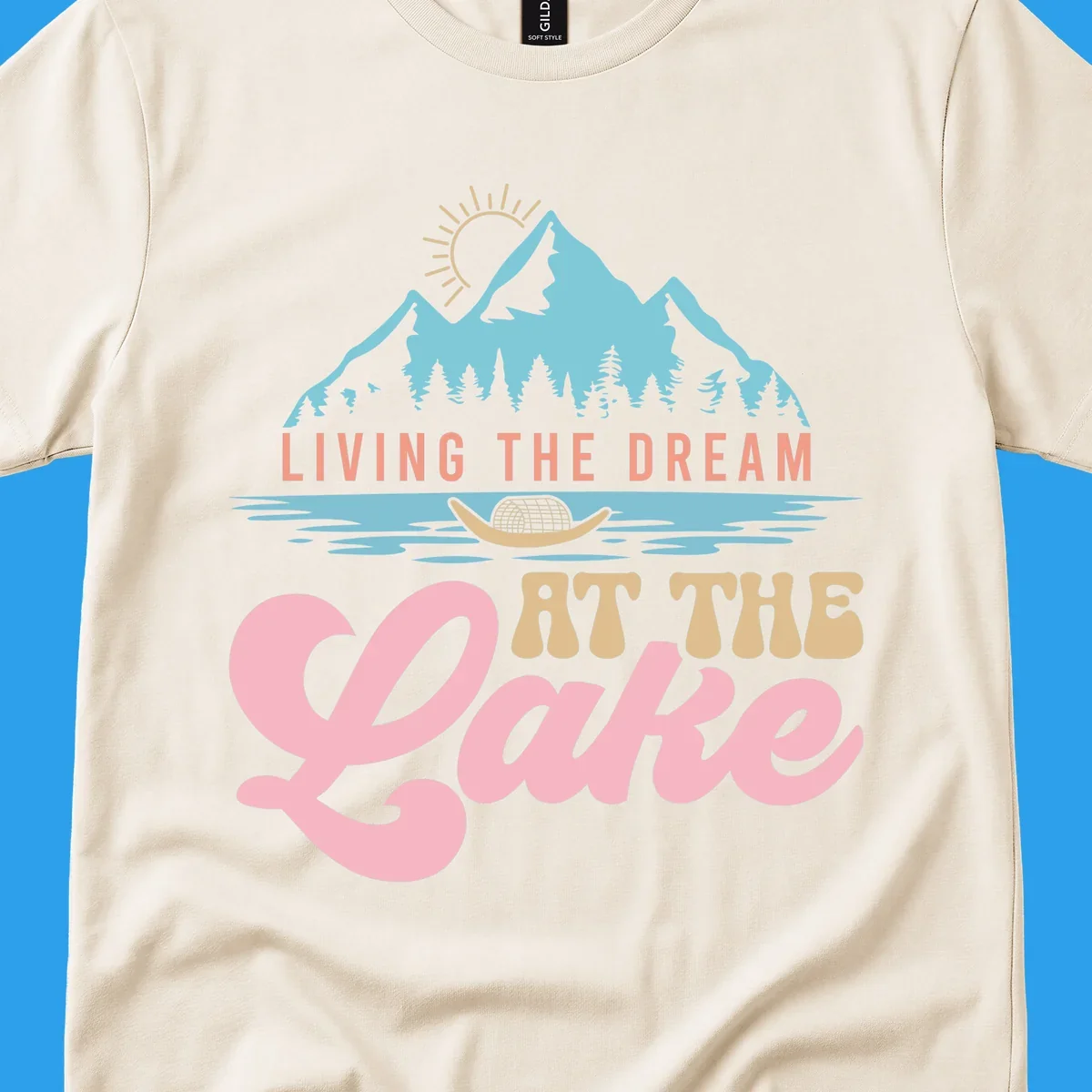 Illustration of mountains and lake with text 'Living The Dream At The Lake', representing the lake-life-dream concept.