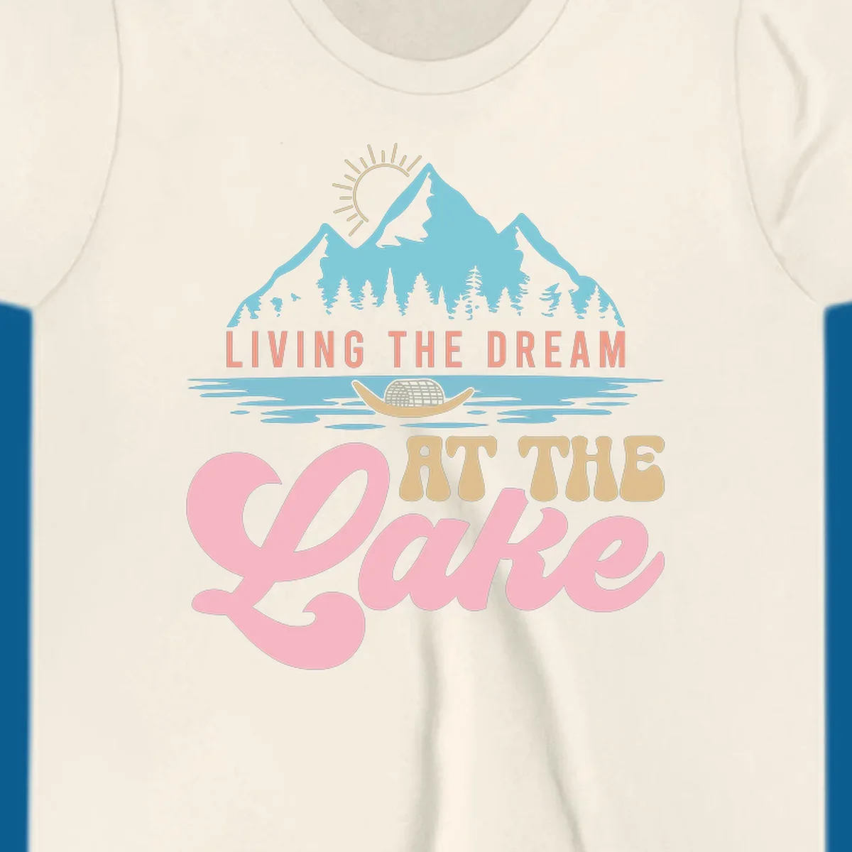 Illustration of mountains and lake with text 'Living The Dream At The Lake', representing the lake-life-dream concept.