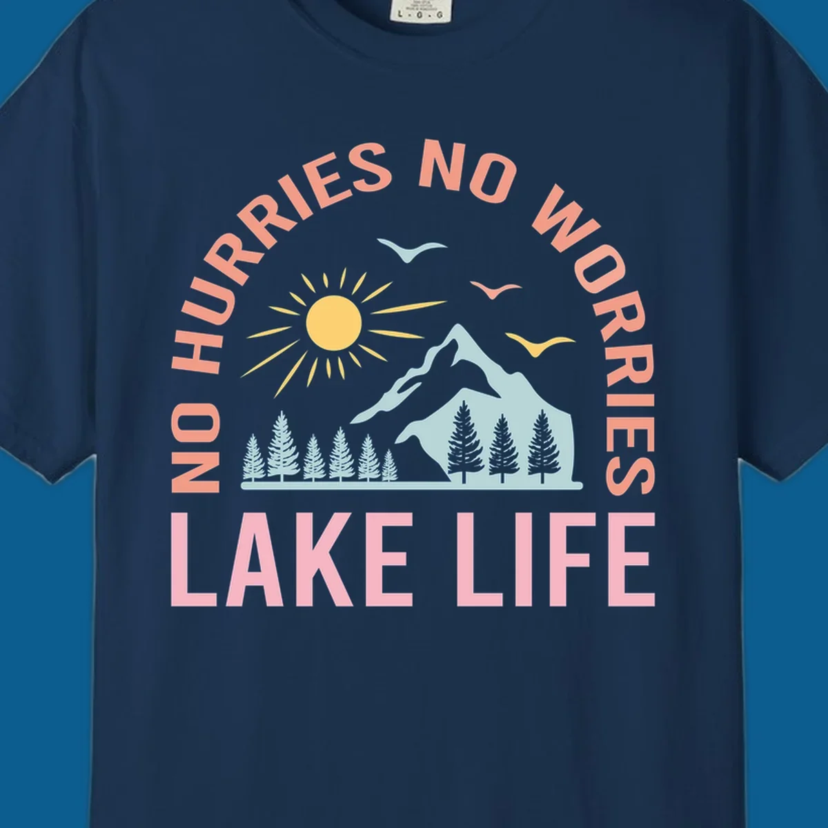 Lake life scenic design with mountains, sun, trees, and no worries text.