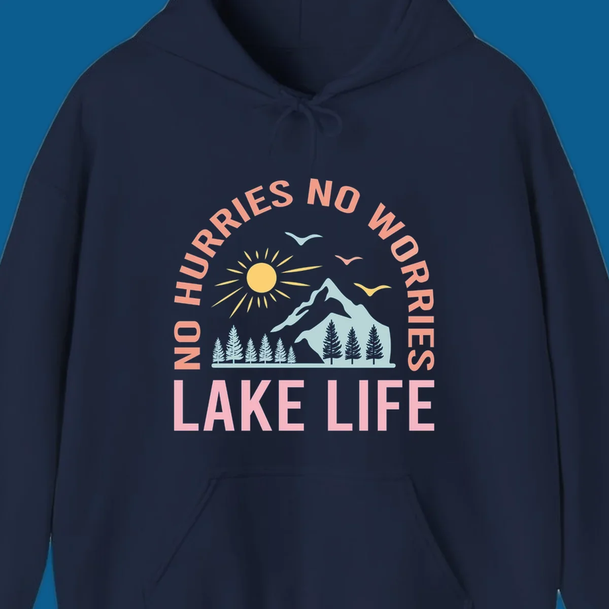 Lake life scenic design with mountains, sun, trees, and no worries text.