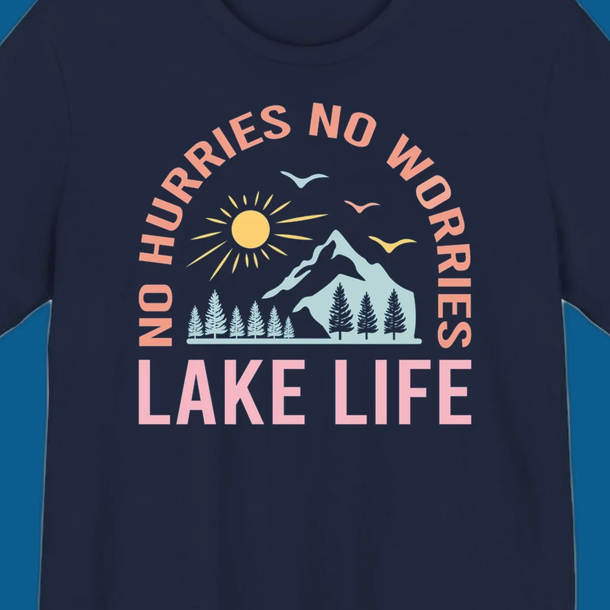 Lake life scenic design with mountains, sun, trees, and no worries text.