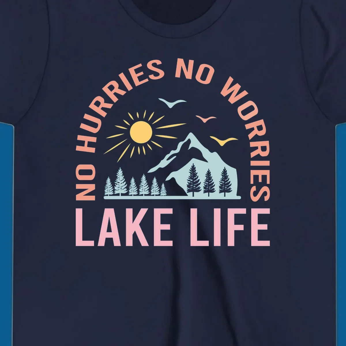 Lake life scenic design with mountains, sun, trees, and no worries text.
