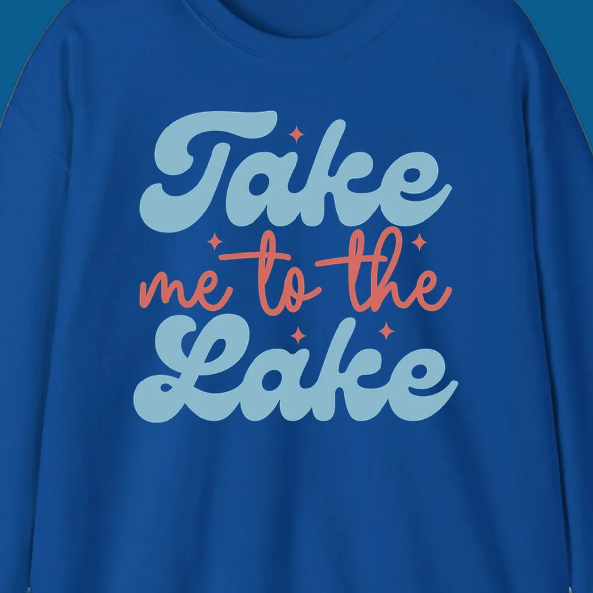 Retro 'Take me to the lake' text design with blue and coral lettering and white starbursts.