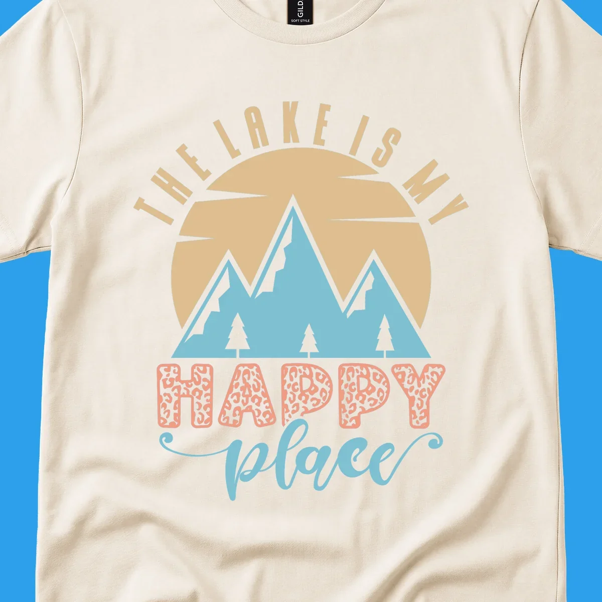 Illustration of mountains and sun with text 'The Lake Is My Happy Place' and leopard print.