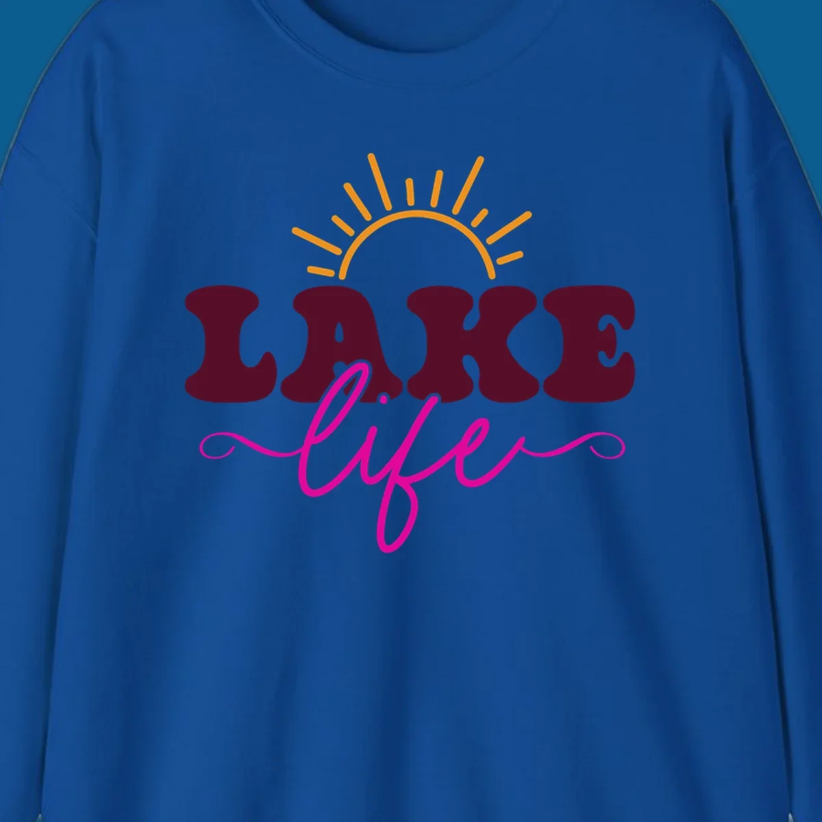 Retro lake life sun graphic with maroon LAKE and pink life text.