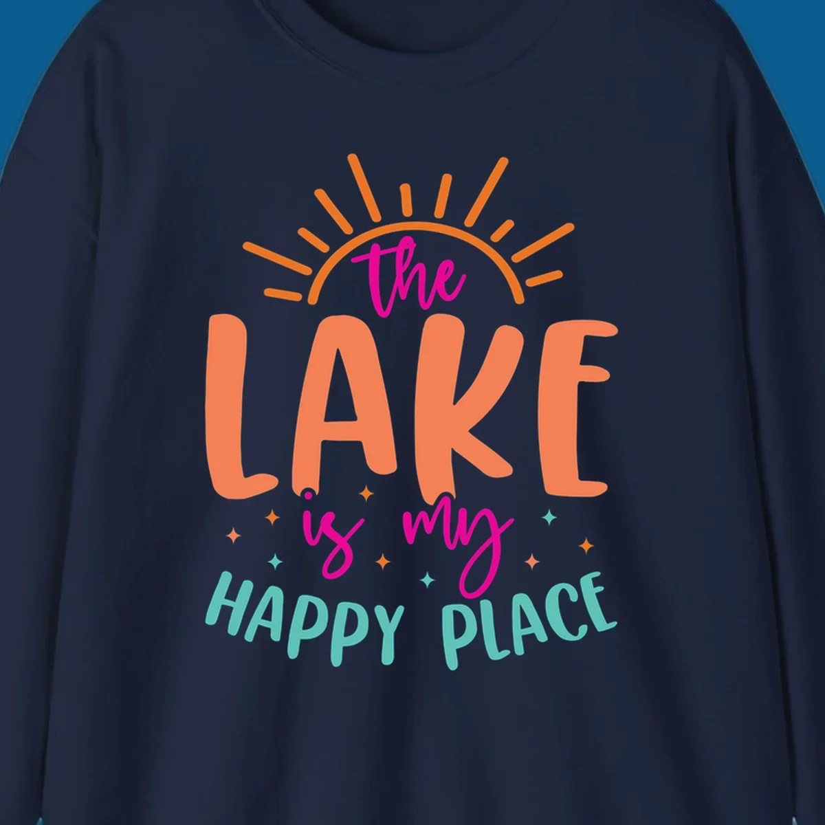 The lake is my happy place text design with sun rays and stars.