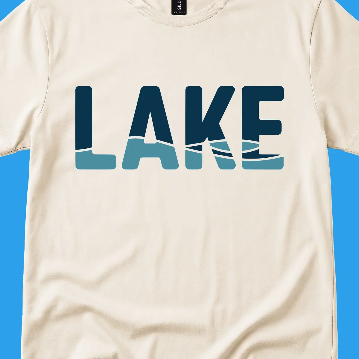 Lake Life Shirt Co. logo with the word LAKE in dark blue with light blue water graphics at the bottom.