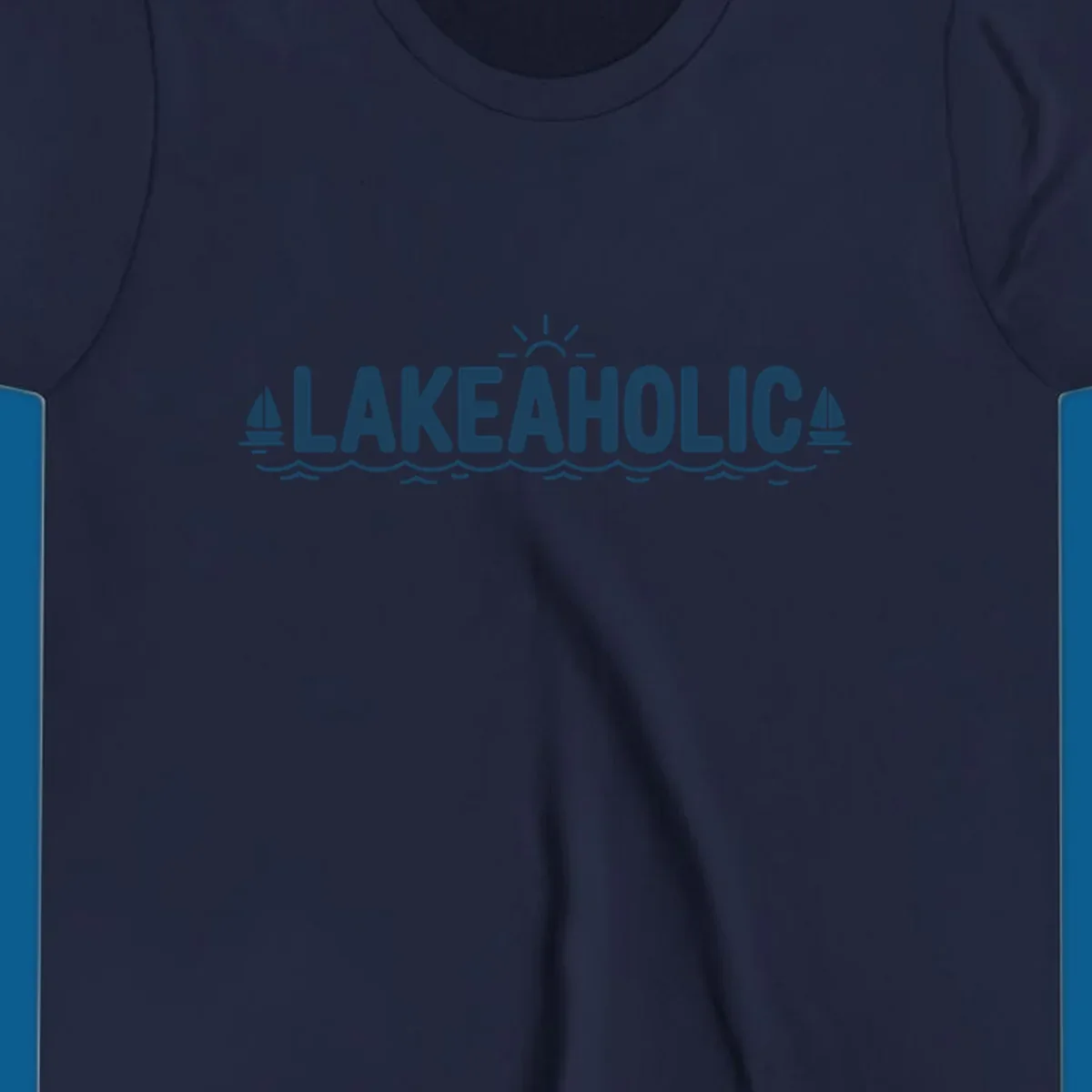 Lakeaholic typography with sun, sailboats, and waves graphic.
