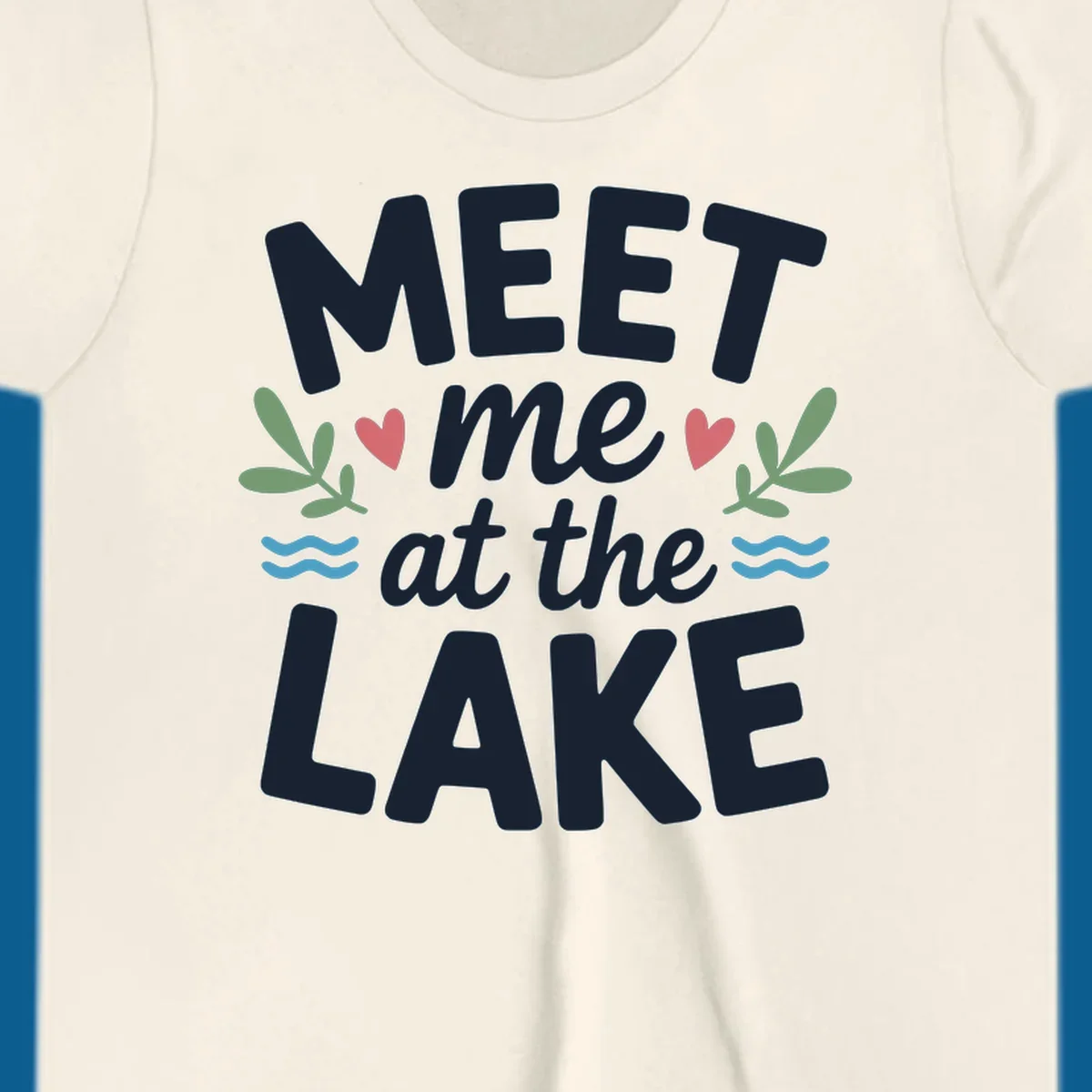 Meet me at the lake typography design with hearts, leaves, and waves.