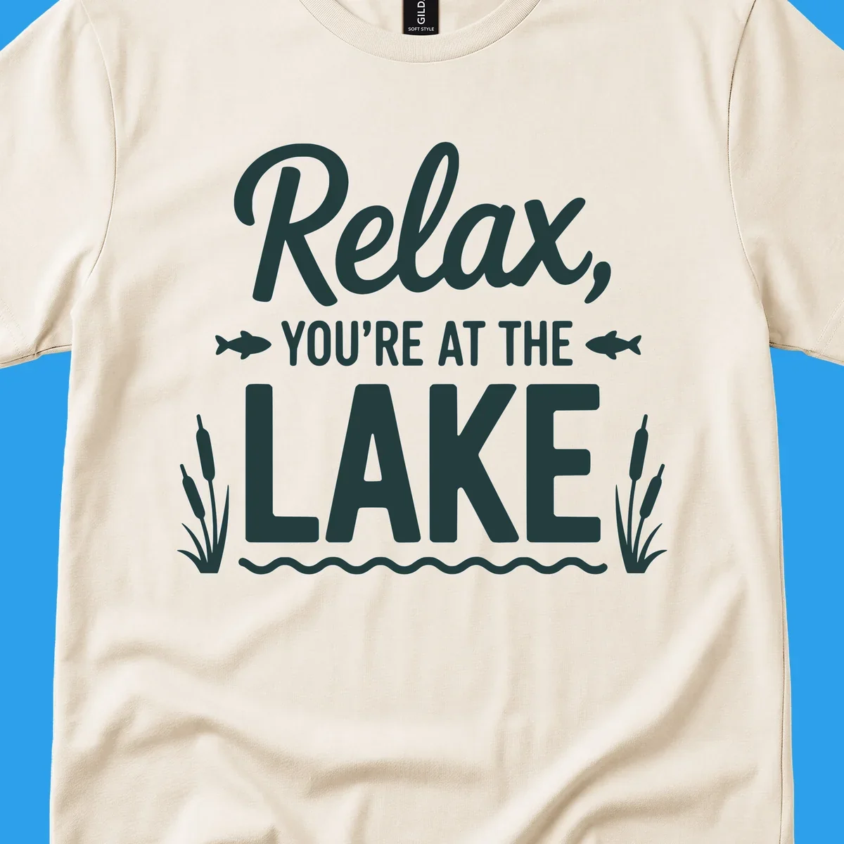 Relax you're at the lake typographic design with fish and cattails.