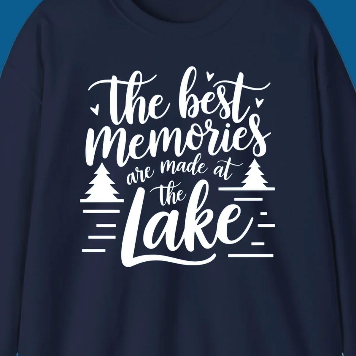 The best memories are made at the lake text with trees and water lines for lake life memories.