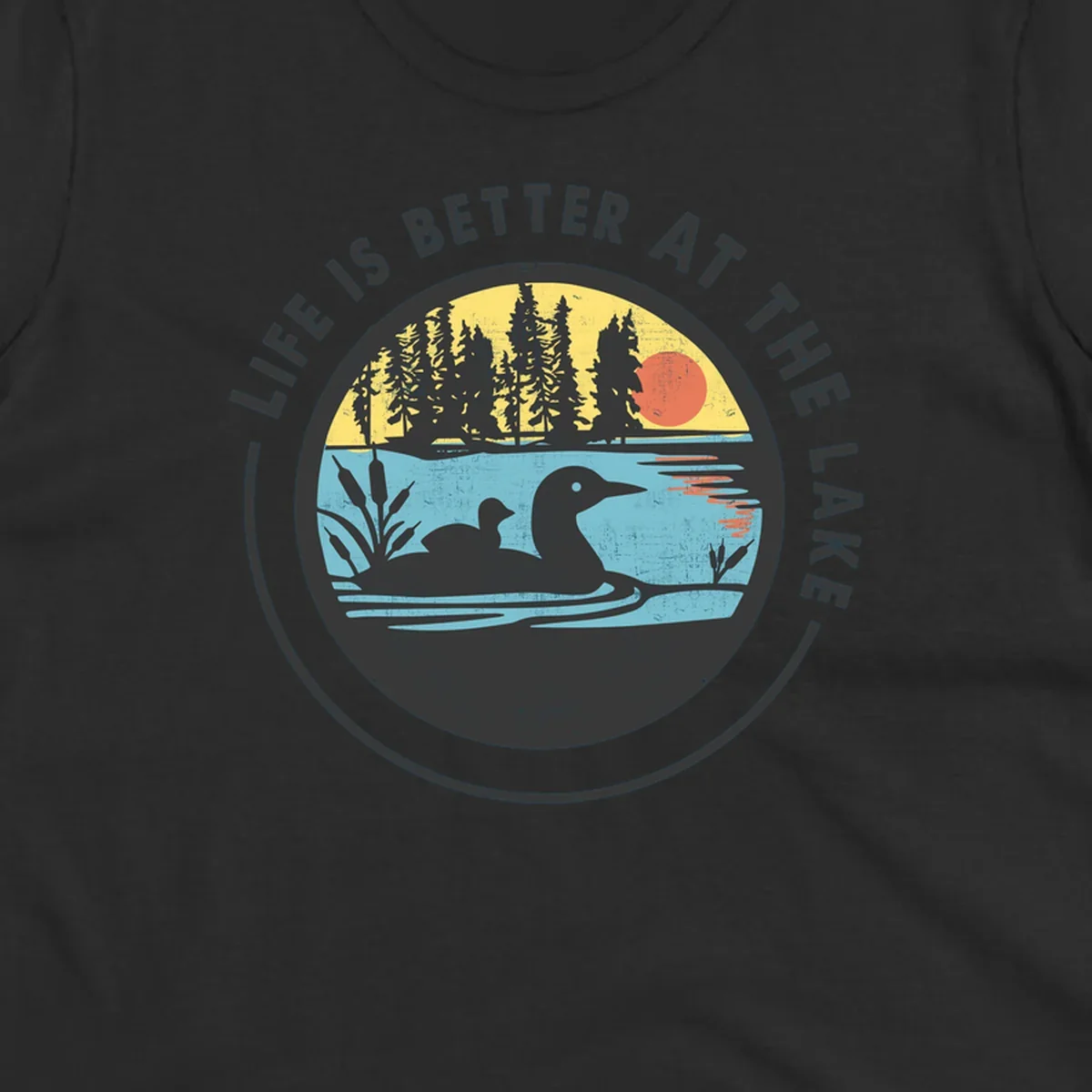 Circular lake scene with loons and trees, text "Life Is Better At The Lake".