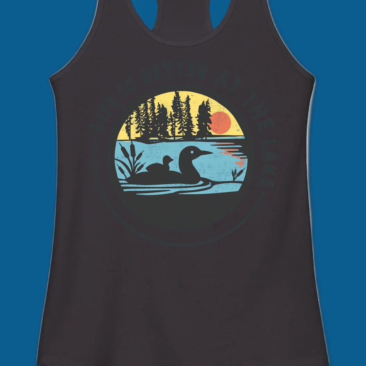 Circular lake scene with loons and trees, text "Life Is Better At The Lake".
