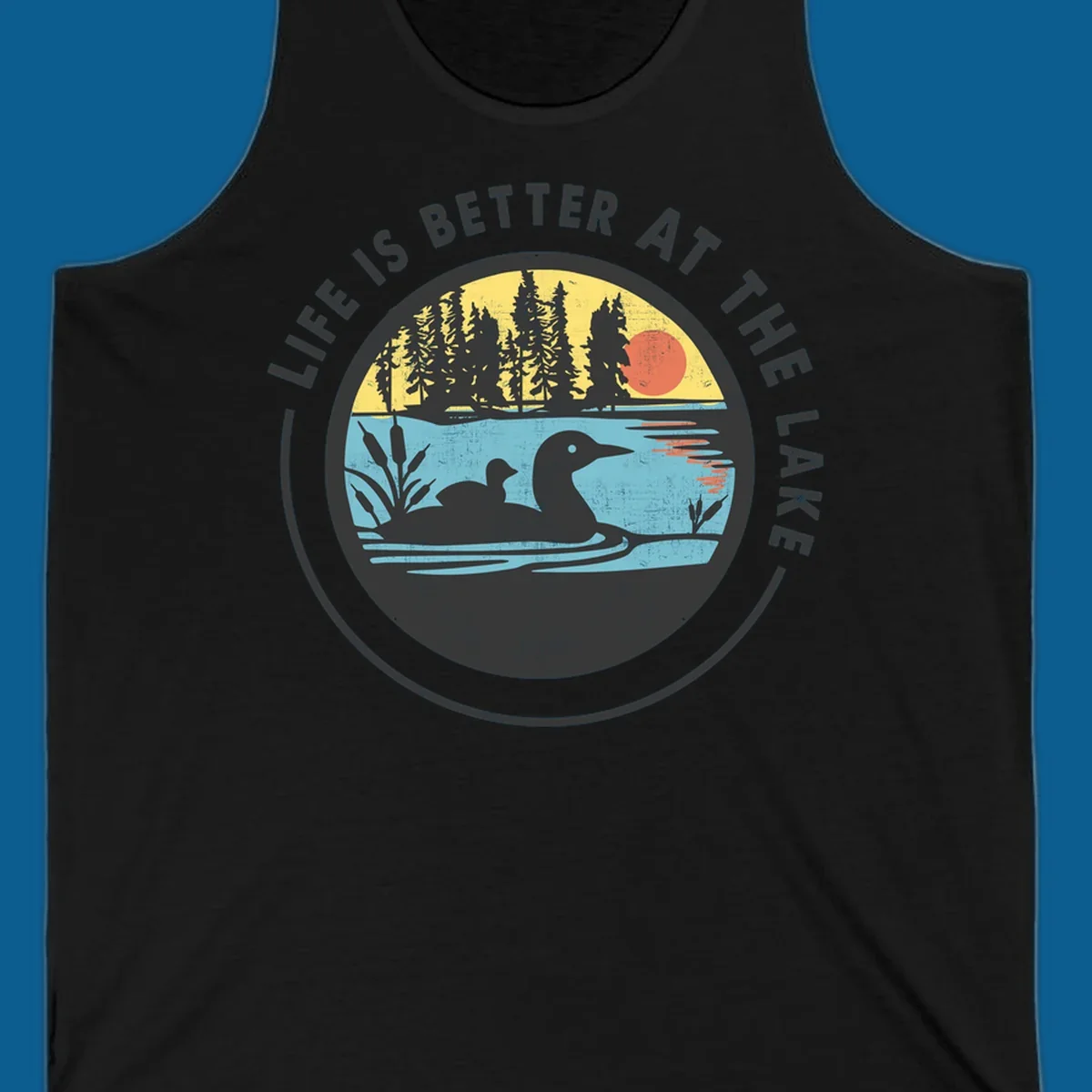 Circular lake scene with loons and trees, text "Life Is Better At The Lake".