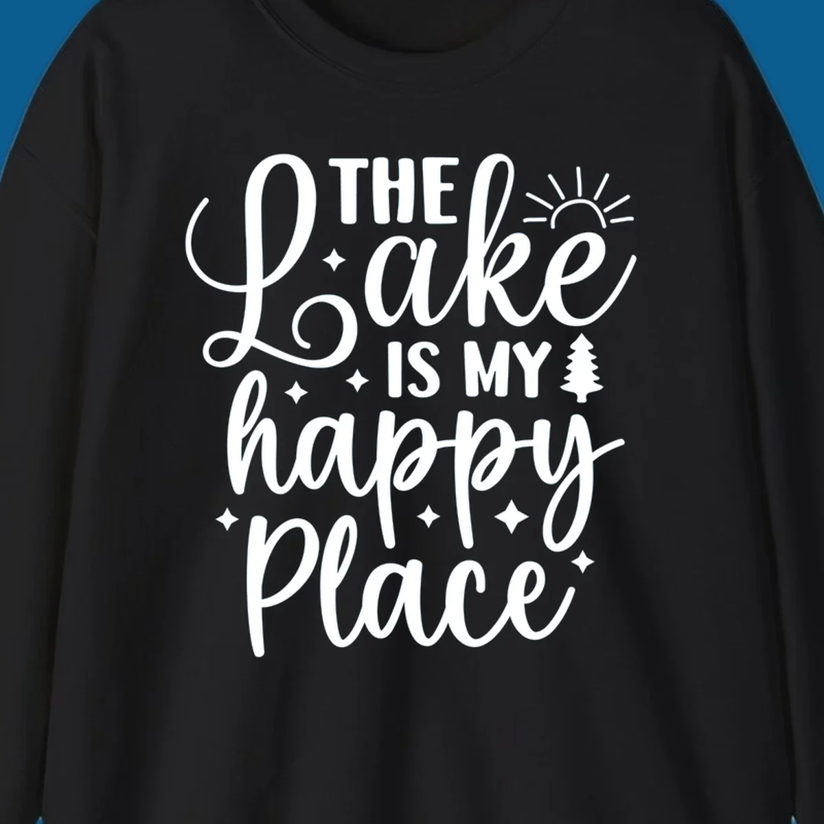 The Lake Is My Happy Place text and graphic design with sun, stars, and tree.