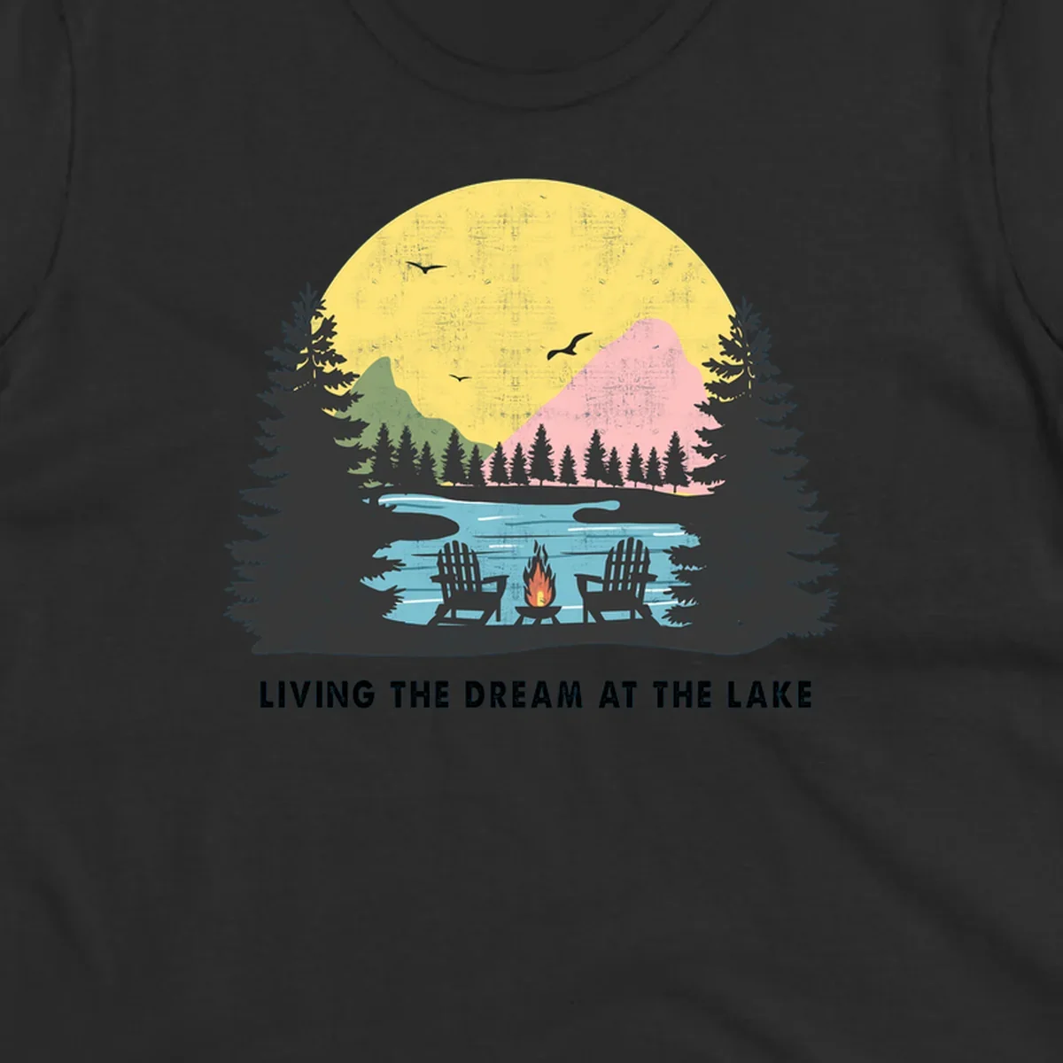 Lake life dream scene with Adirondack chairs, campfire, and sunset over mountains. Text: LIVING THE DREAM AT THE LAKE