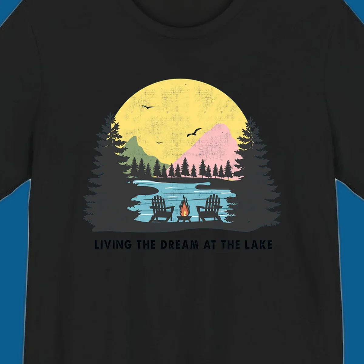 Lake life dream scene with Adirondack chairs, campfire, and sunset over mountains. Text: LIVING THE DREAM AT THE LAKE