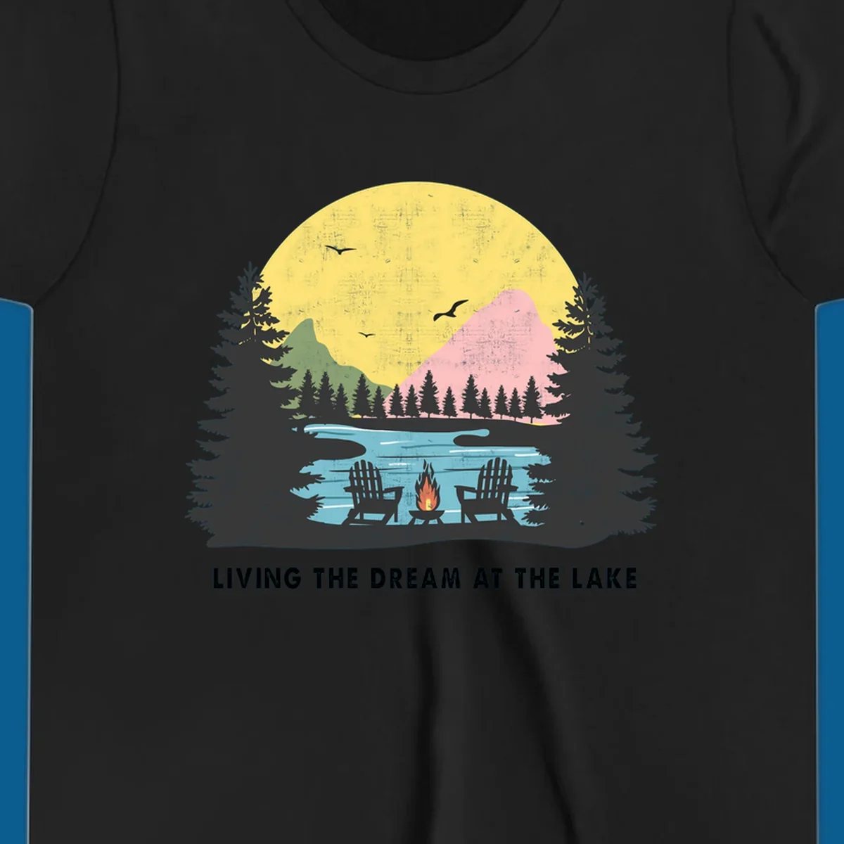 Lake life dream scene with Adirondack chairs, campfire, and sunset over mountains. Text: LIVING THE DREAM AT THE LAKE