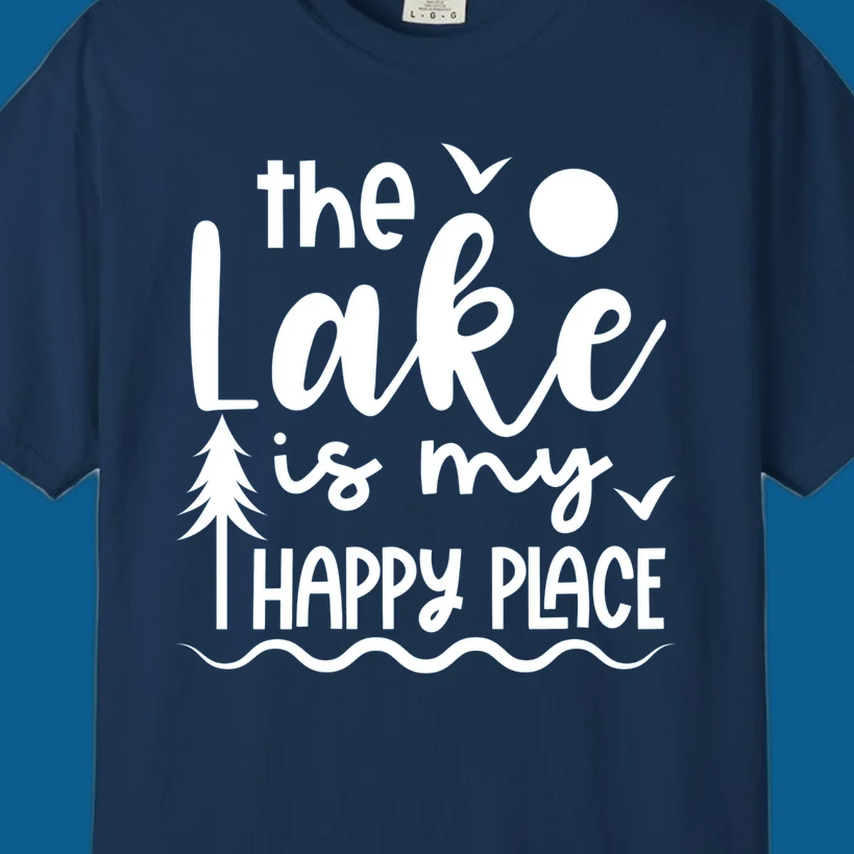 The Lake Is My Happy Place text design with lake elements like a tree, sun, and birds.