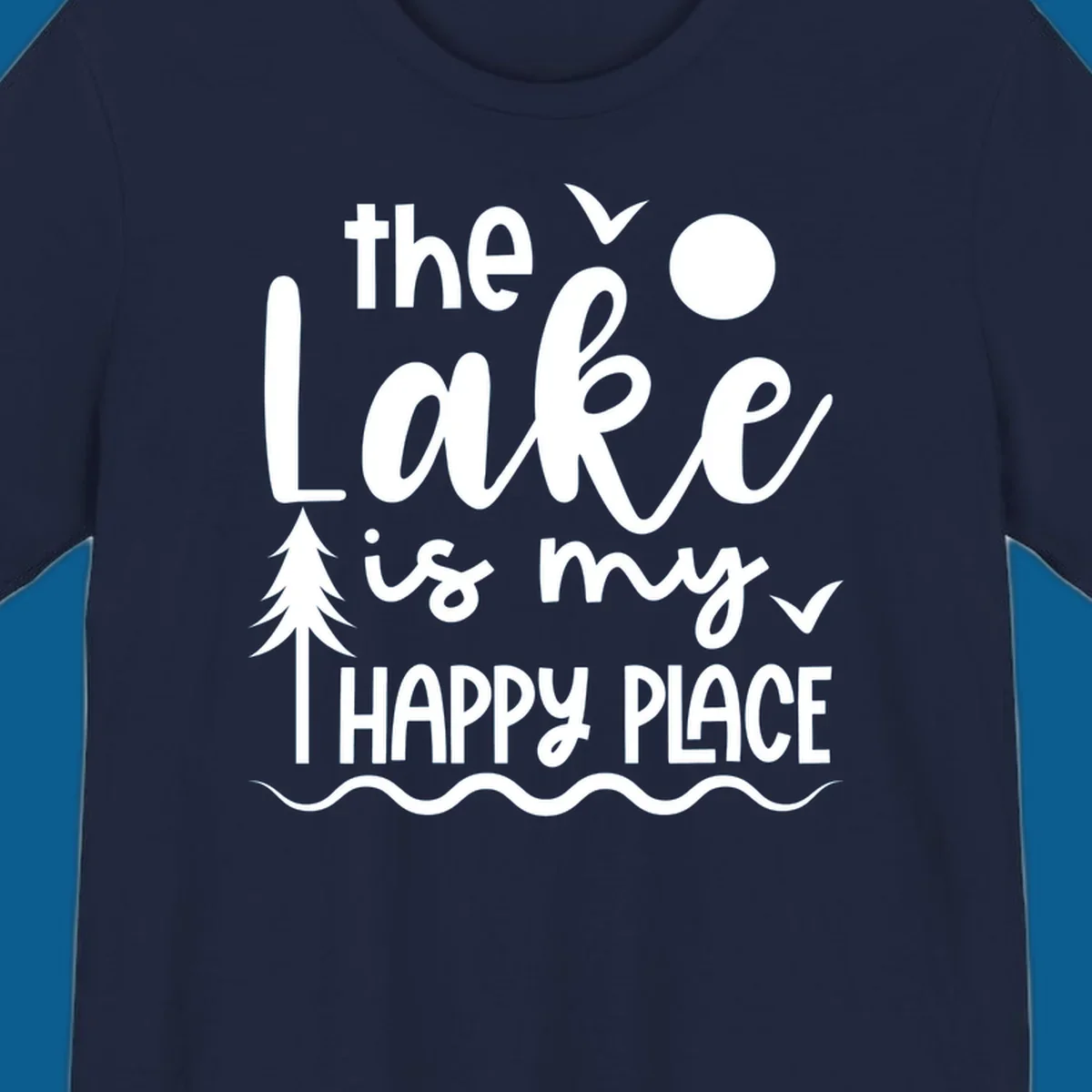 The Lake Is My Happy Place text design with lake elements like a tree, sun, and birds.