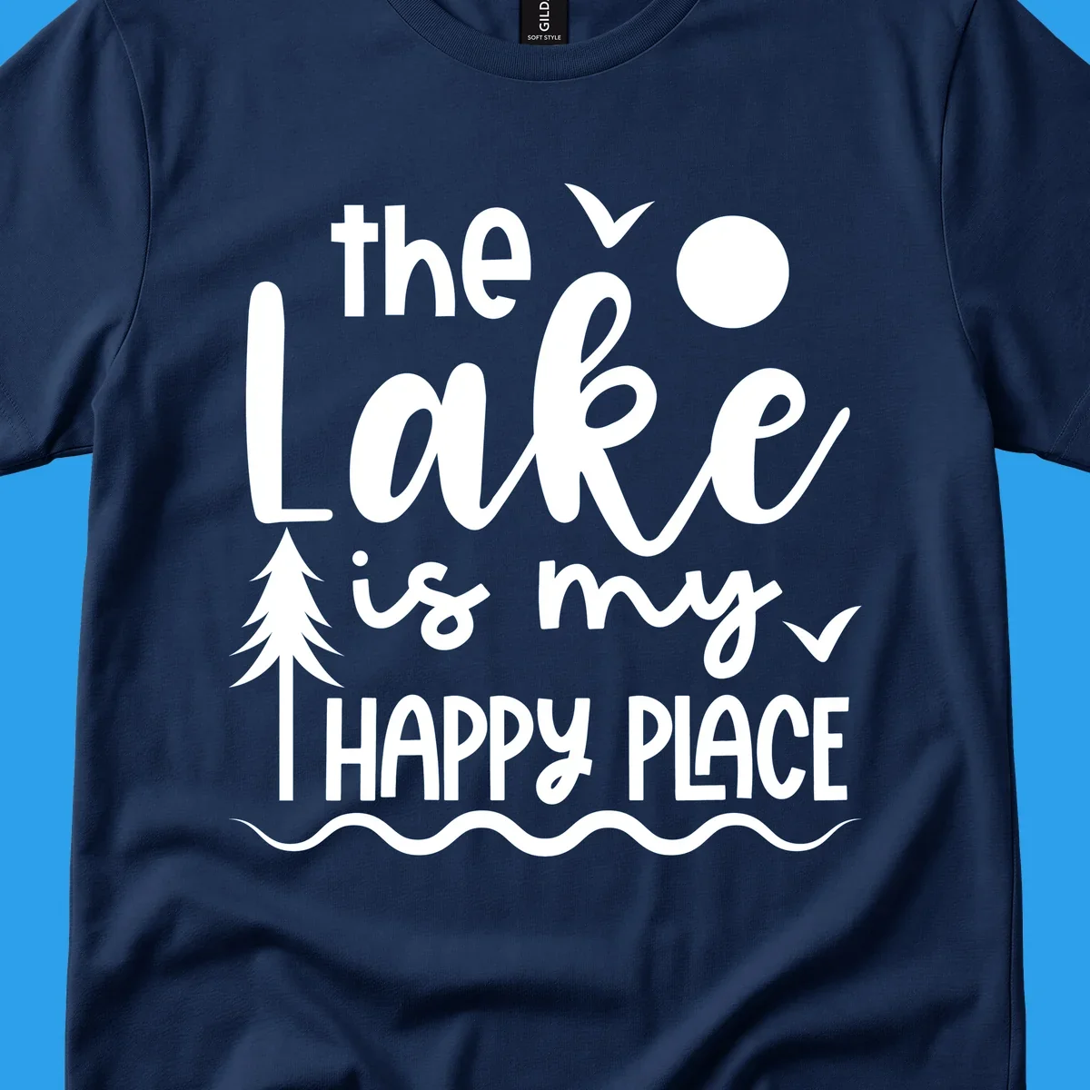 The Lake Is My Happy Place text design with lake elements like a tree, sun, and birds.