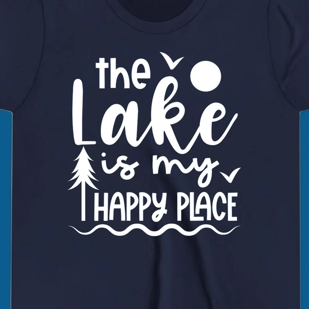 The Lake Is My Happy Place text design with lake elements like a tree, sun, and birds.