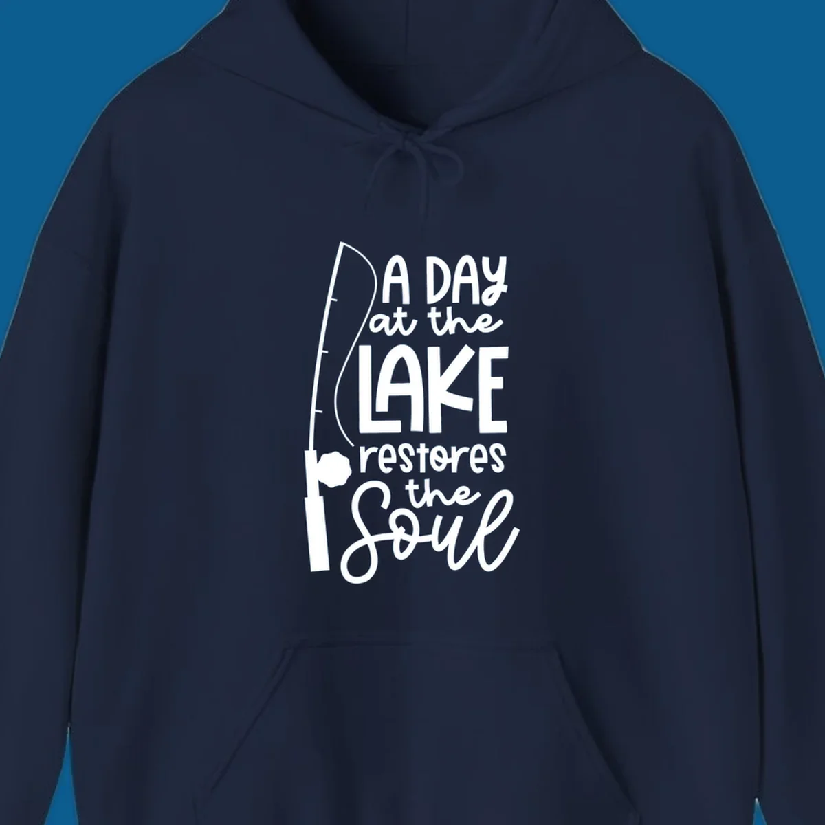 Fishing pole with text "A Day at the Lake Restores the Soul", lake-life concept.