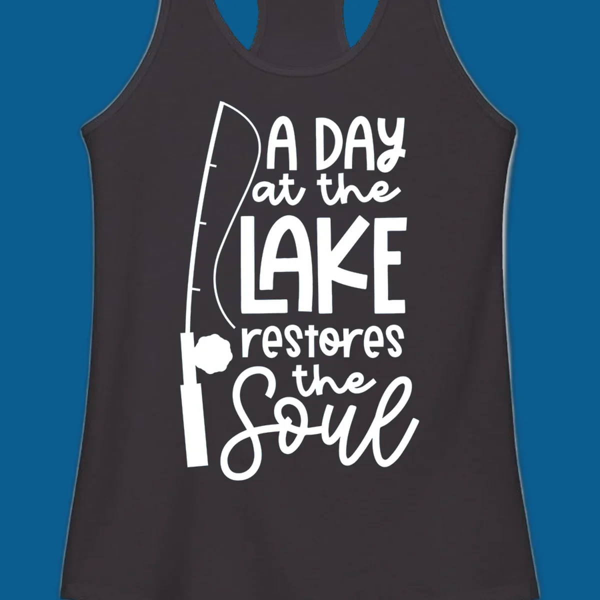 Fishing pole with text "A Day at the Lake Restores the Soul", lake-life concept.