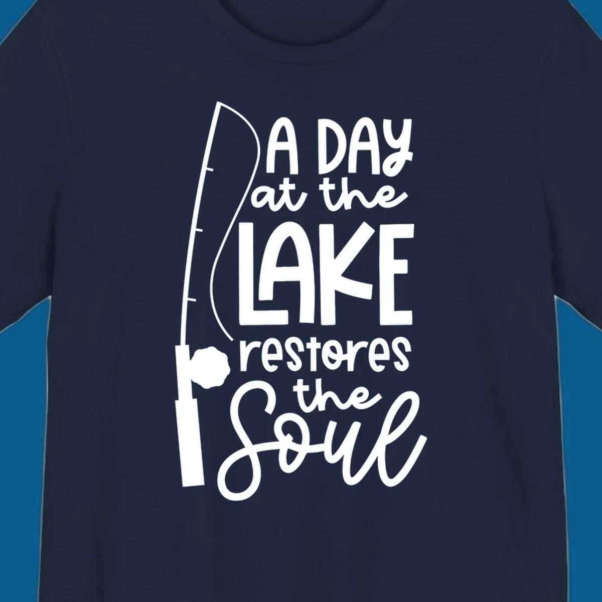 Fishing pole with text "A Day at the Lake Restores the Soul", lake-life concept.