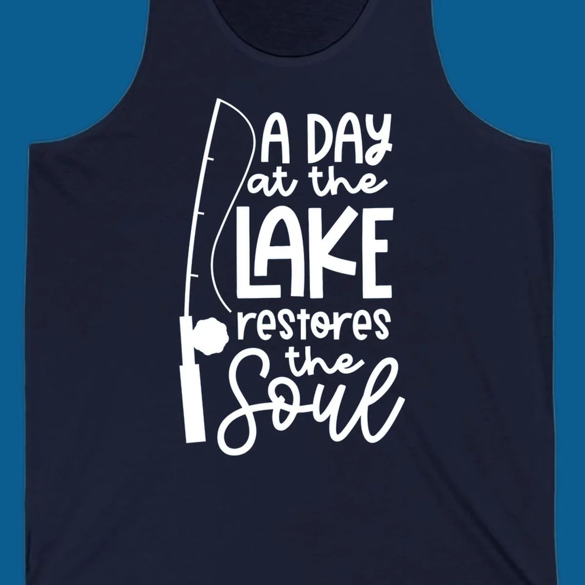 Fishing pole with text "A Day at the Lake Restores the Soul", lake-life concept.