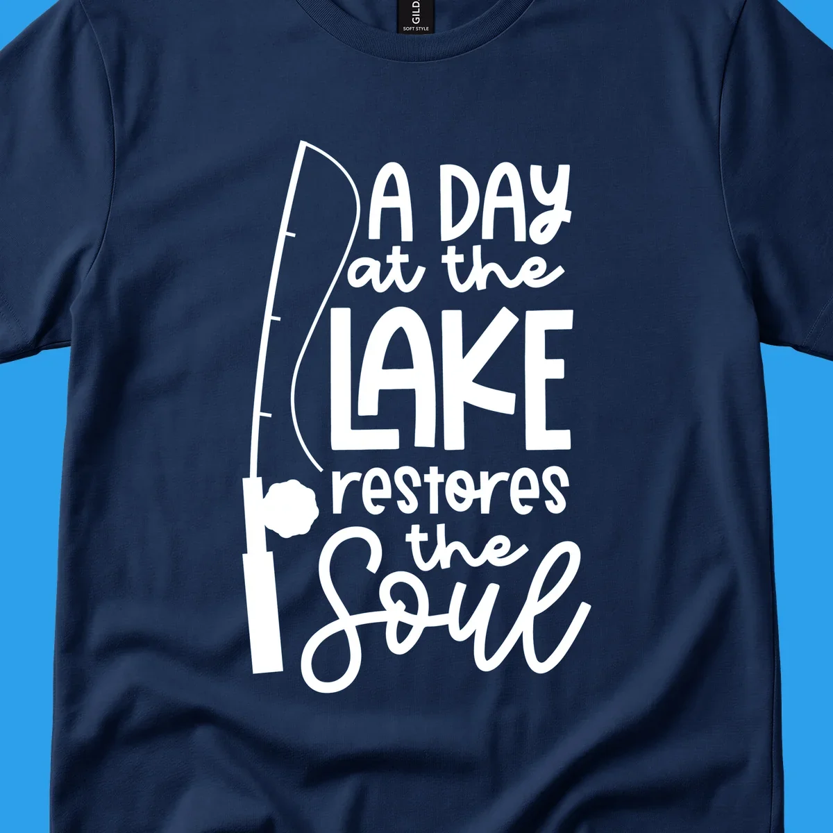 Fishing pole with text "A Day at the Lake Restores the Soul", lake-life concept.