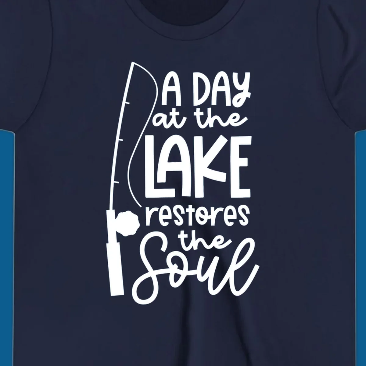 Fishing pole with text "A Day at the Lake Restores the Soul", lake-life concept.
