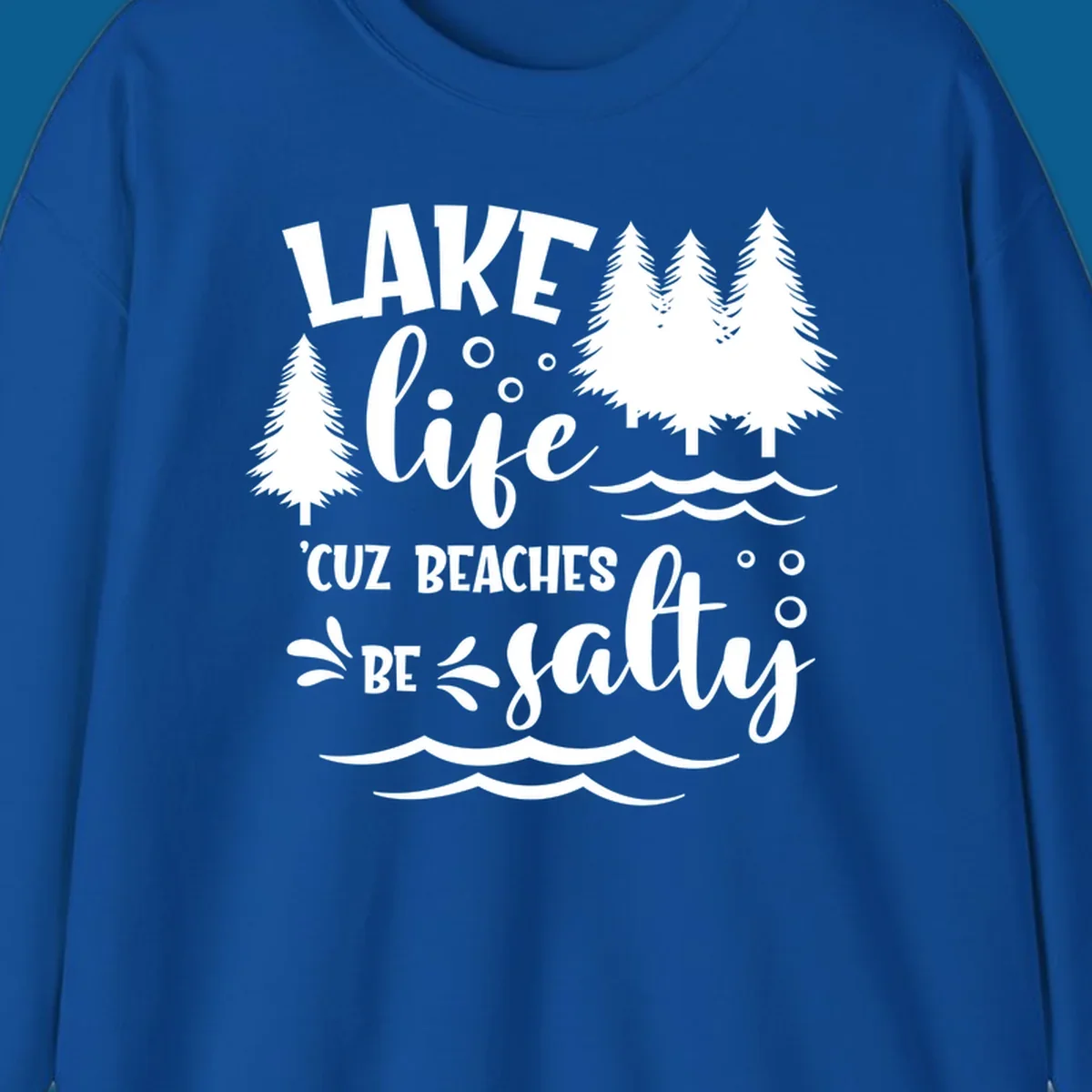 Lake life graphic with text 'LAKE life 'CUZ BEACHES BE salty', pine trees, and water waves.