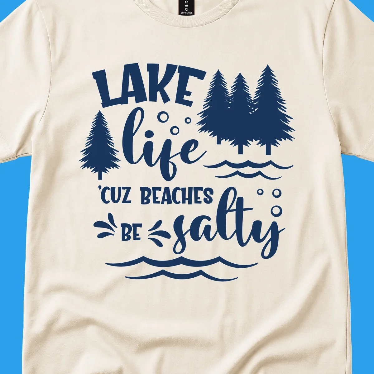 Lake life graphic with text 'LAKE life 'CUZ BEACHES BE salty', pine trees, and water waves.