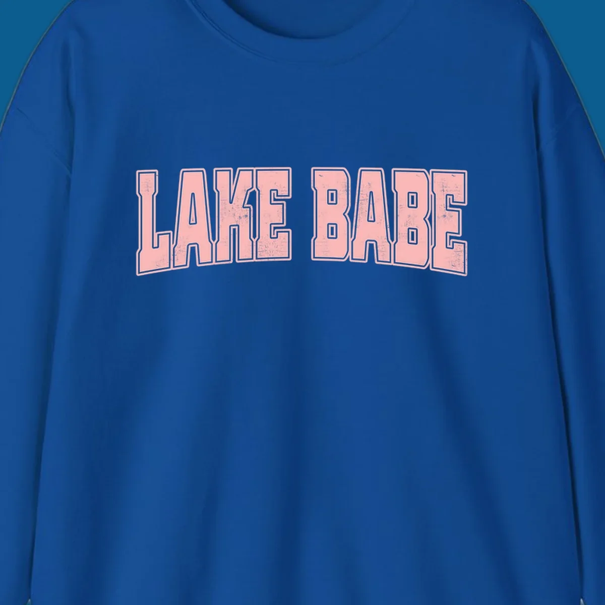 Lake Babe text design in pink with distressed texture and black outline.