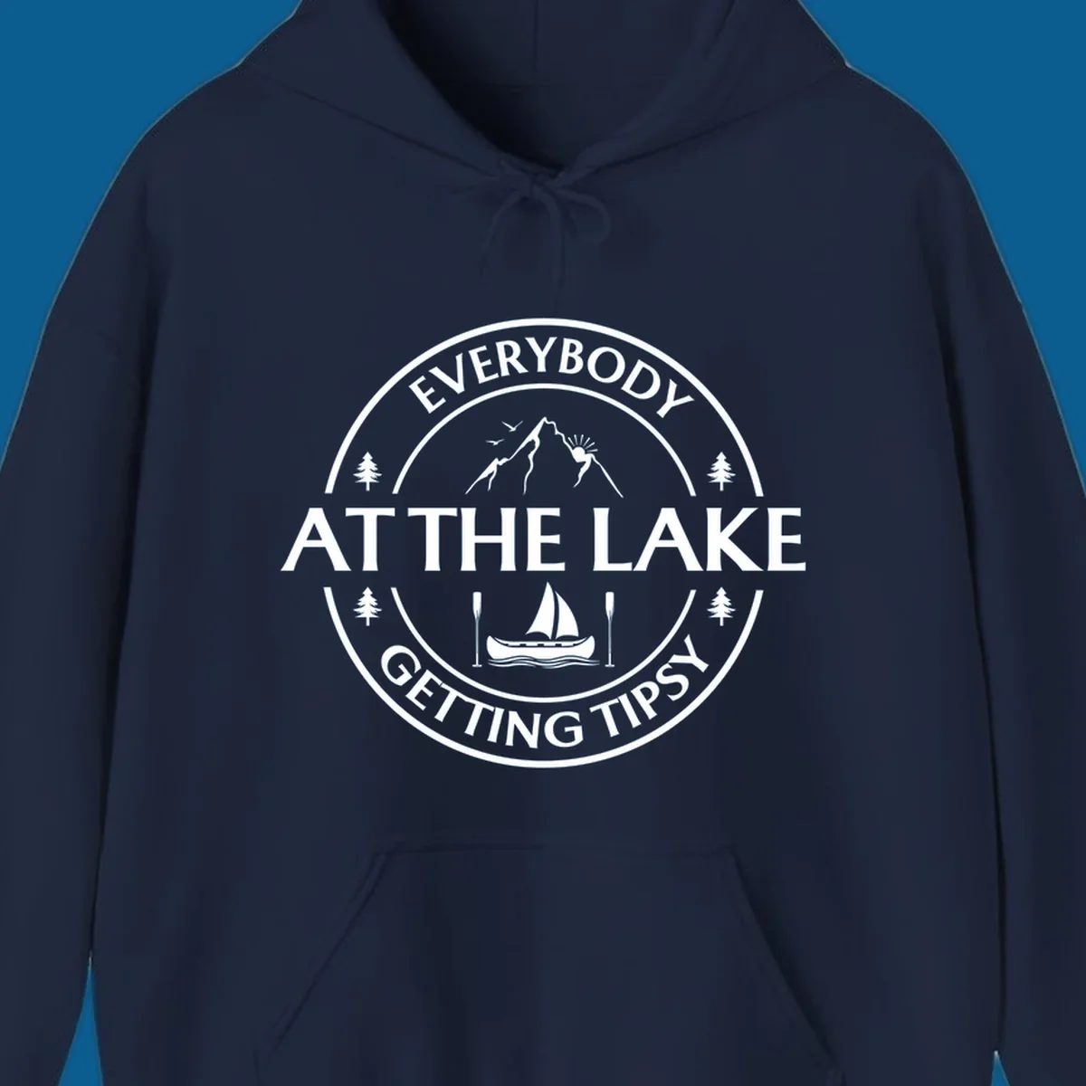 Circular badge design for lake life featuring mountains, canoe, and text 'Everybody At The Lake Getting Tipsy'.
