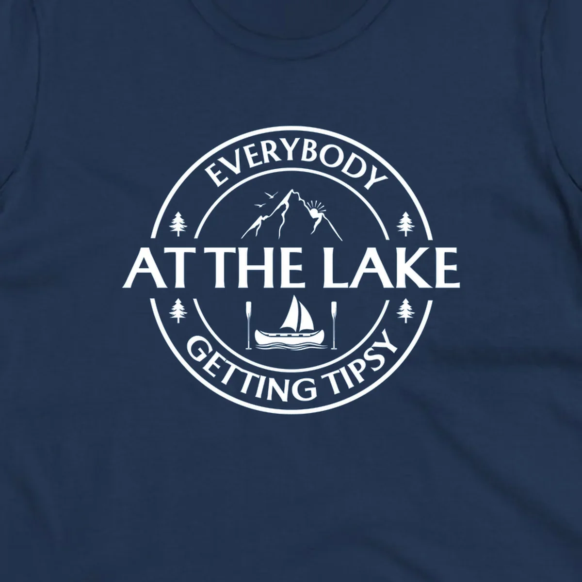 Circular badge design for lake life featuring mountains, canoe, and text 'Everybody At The Lake Getting Tipsy'.