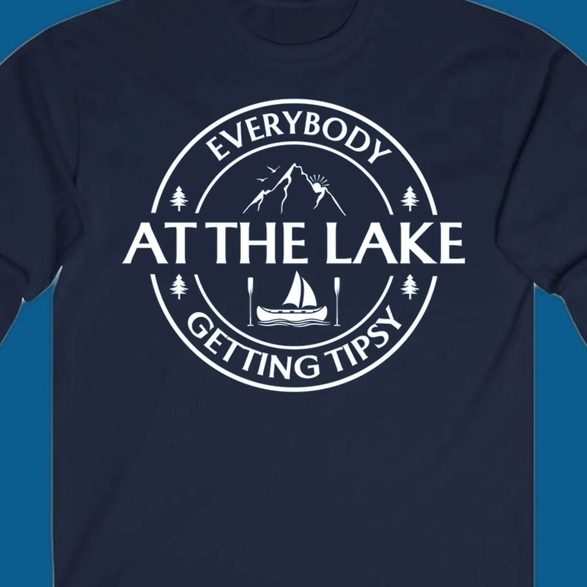 Circular badge design for lake life featuring mountains, canoe, and text 'Everybody At The Lake Getting Tipsy'.