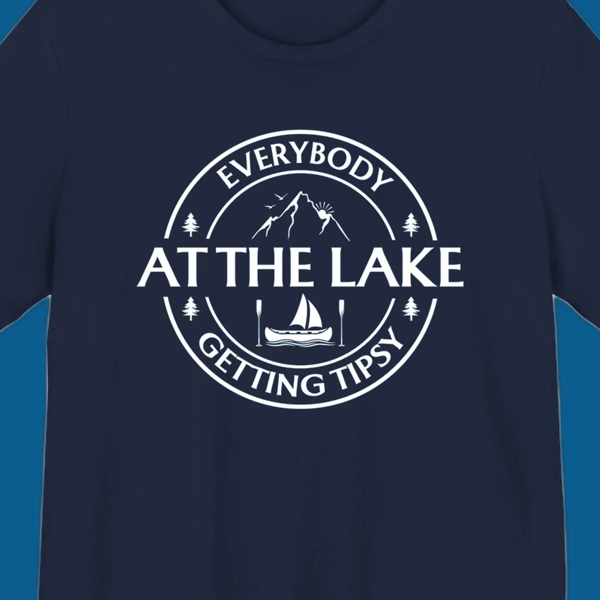 Circular badge design for lake life featuring mountains, canoe, and text 'Everybody At The Lake Getting Tipsy'.