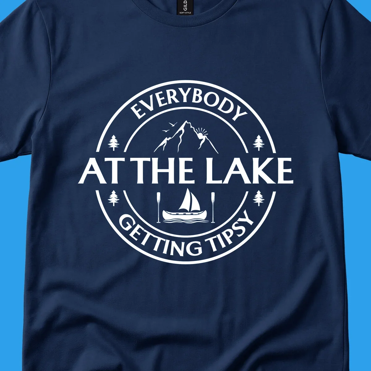 Circular badge design for lake life featuring mountains, canoe, and text 'Everybody At The Lake Getting Tipsy'.
