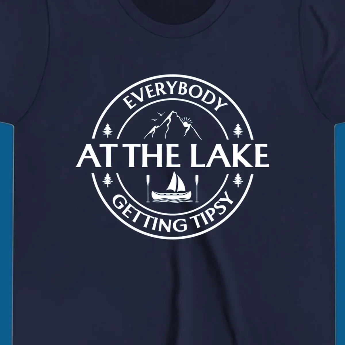 Circular badge design for lake life featuring mountains, canoe, and text 'Everybody At The Lake Getting Tipsy'.