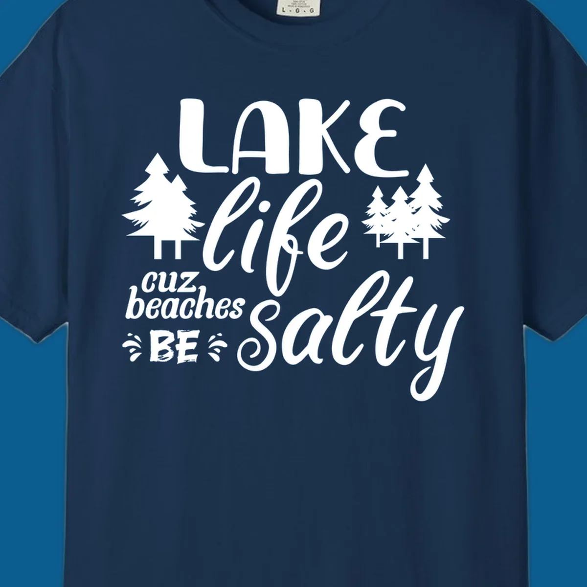 Lake life cuz beaches be salty text and pine trees graphic.