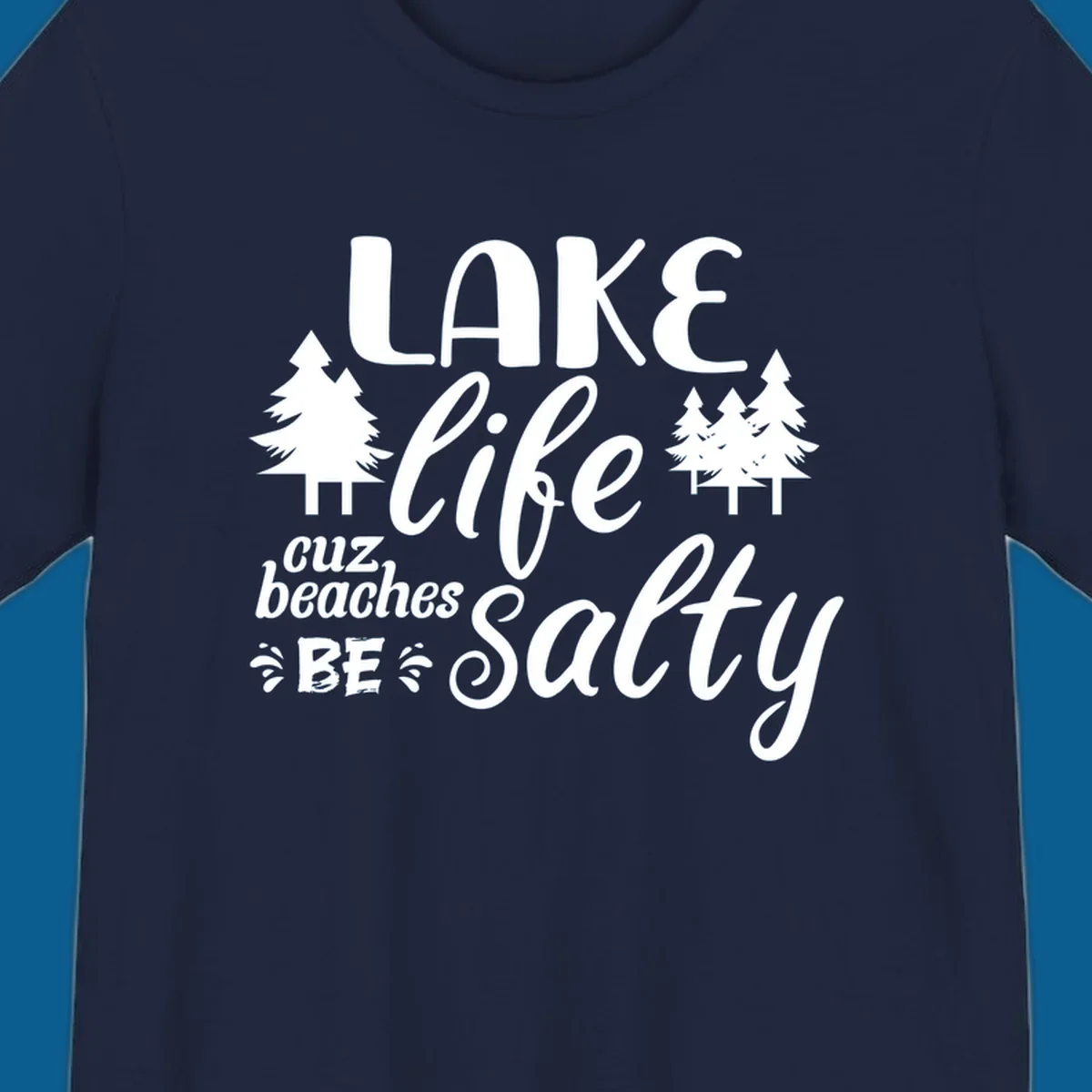 Lake life cuz beaches be salty text and pine trees graphic.