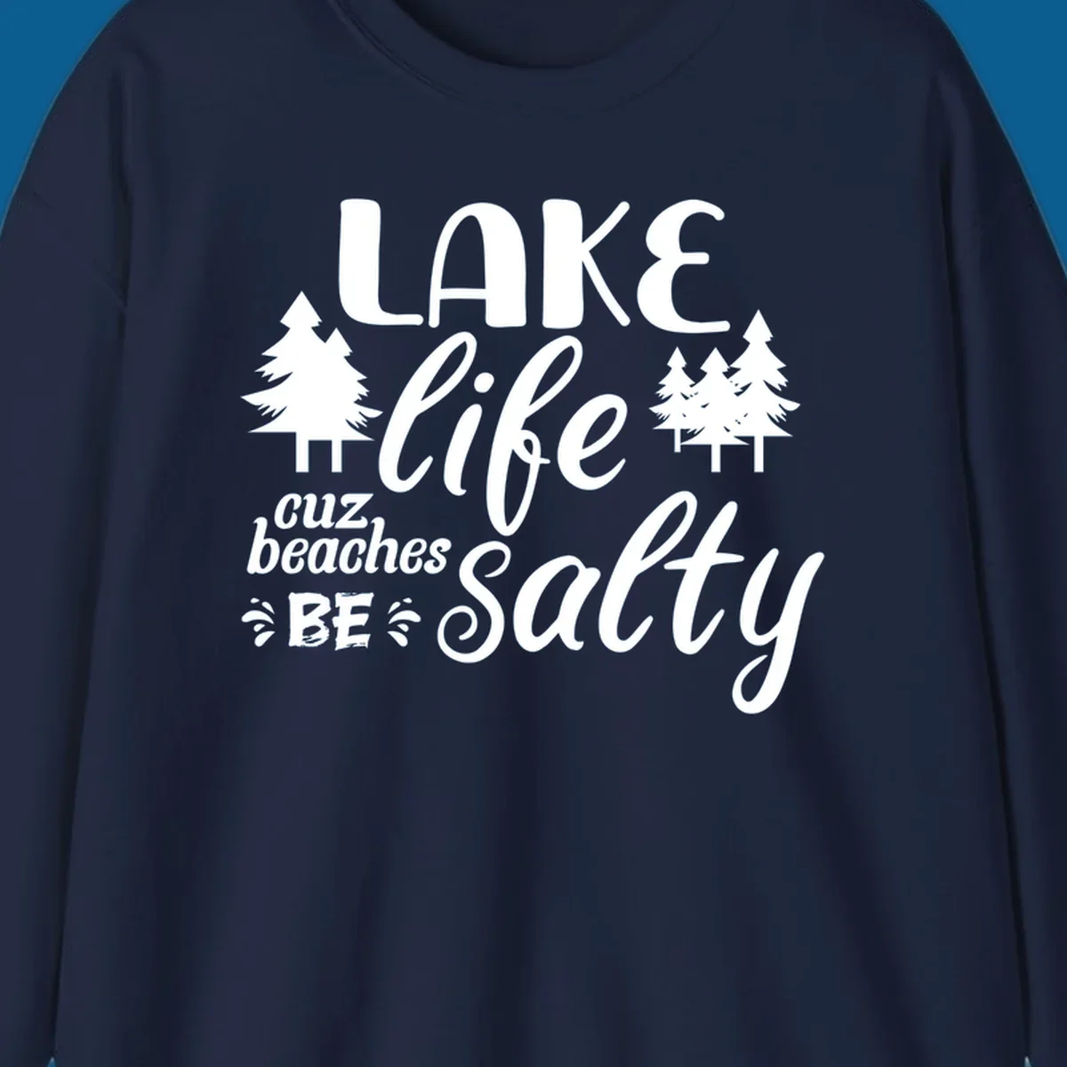 Lake life cuz beaches be salty text and pine trees graphic.