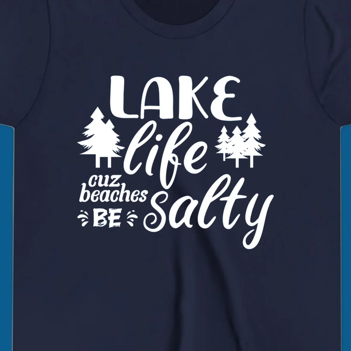 Lake life cuz beaches be salty text and pine trees graphic.