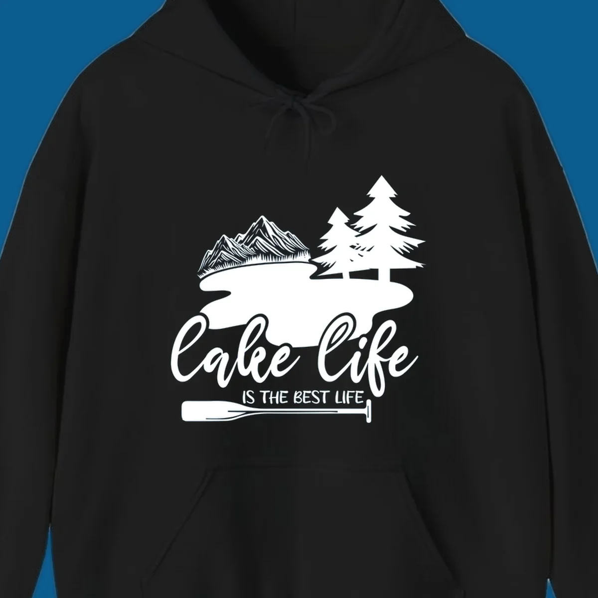 Lake life is the best life design with mountains, trees, lake, and paddle graphic.