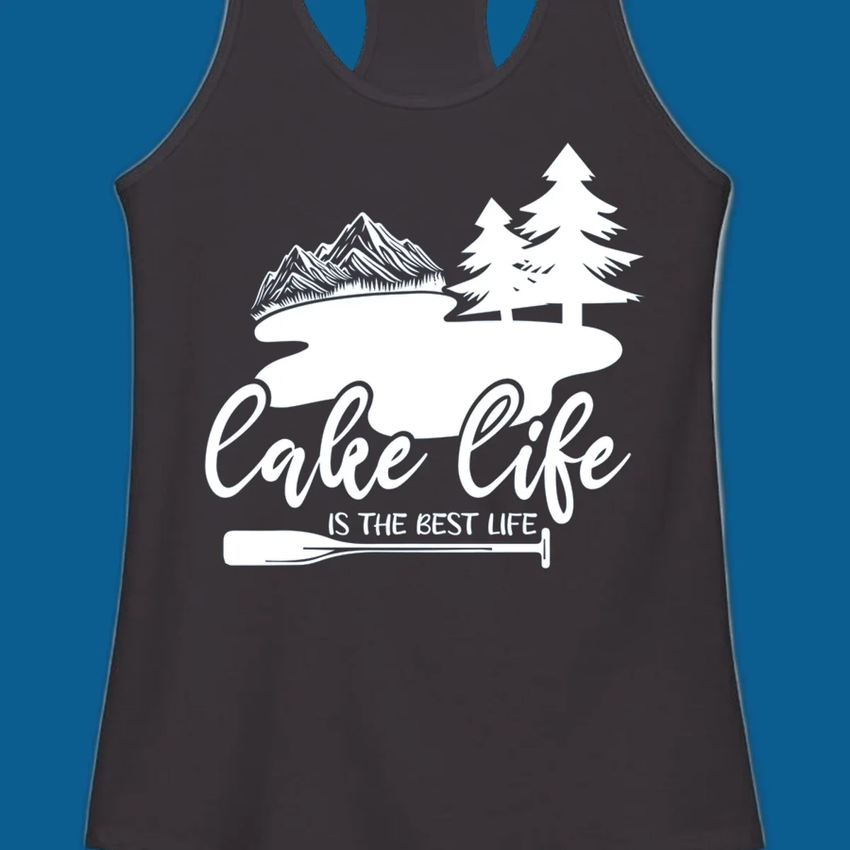 Lake life is the best life design with mountains, trees, lake, and paddle graphic.