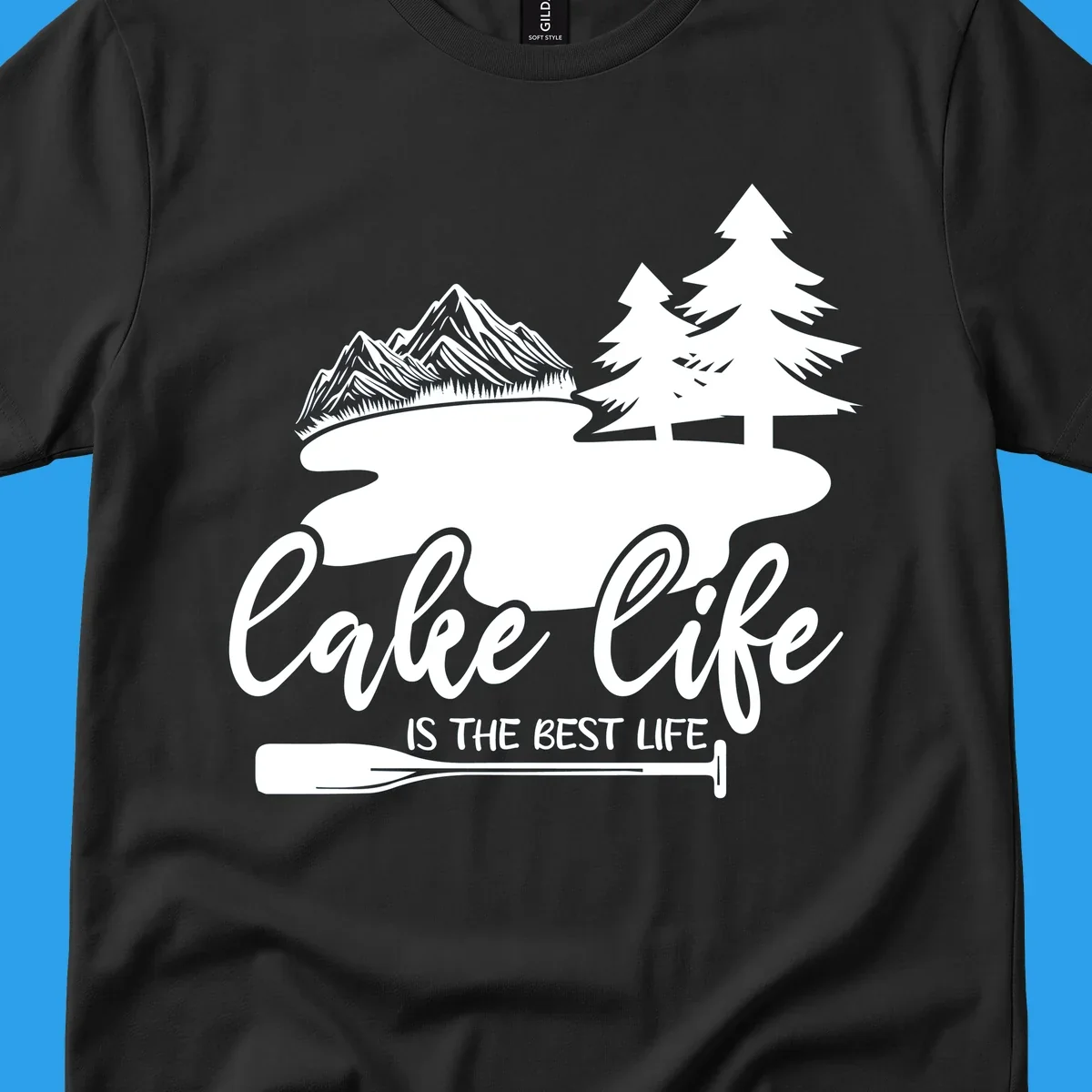 Lake life is the best life design with mountains, trees, lake, and paddle graphic.