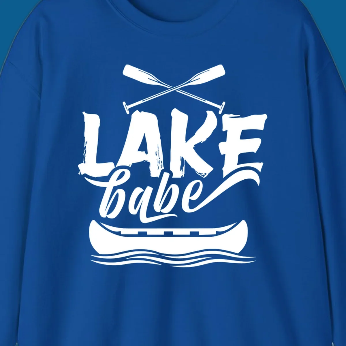 Lake babe text with canoe and oars on water. Primary keyword: lake-babe-canoe